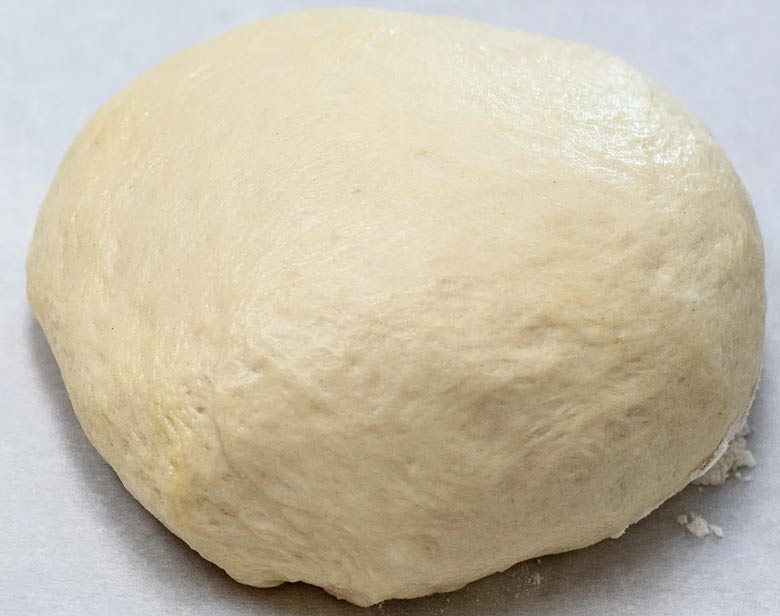 placing pizza dough on the countertop