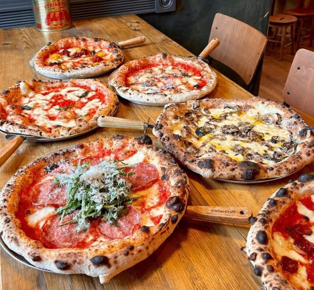 Five italian pizzas in display