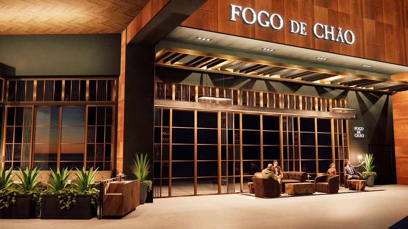 Exterior of a Fogo de Chão restaurant at night with glass windows, wooden panels, signage, and outdoor seating