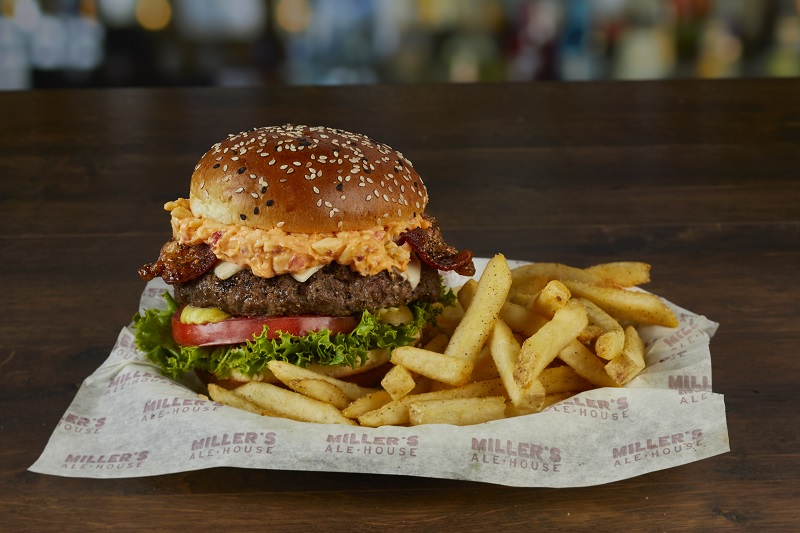 A burger with chips on the side from the Miller’s Ale House menu