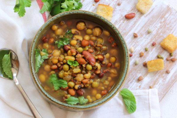 Cooked great northern beans in a colorful soup