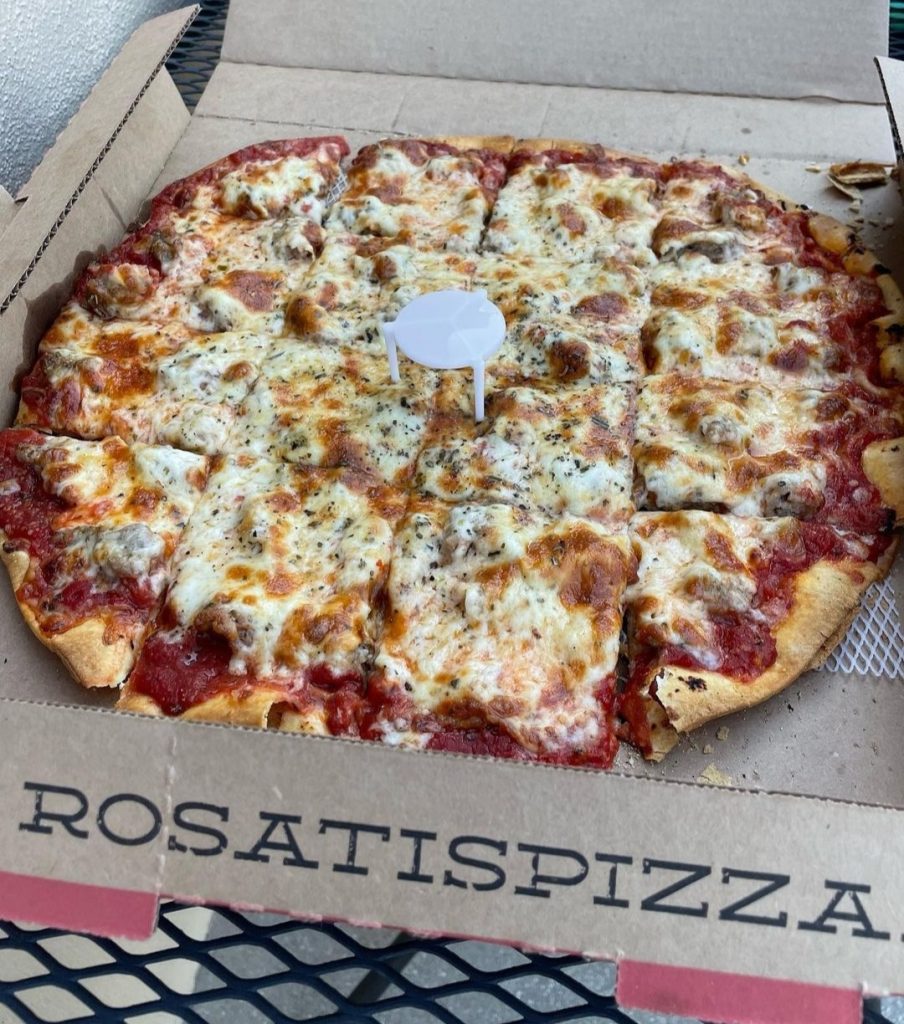 Freshly baked pizza from Rosati's Pizza menu, topped with melted cheese and herbs, served in a box for convenient delivery.