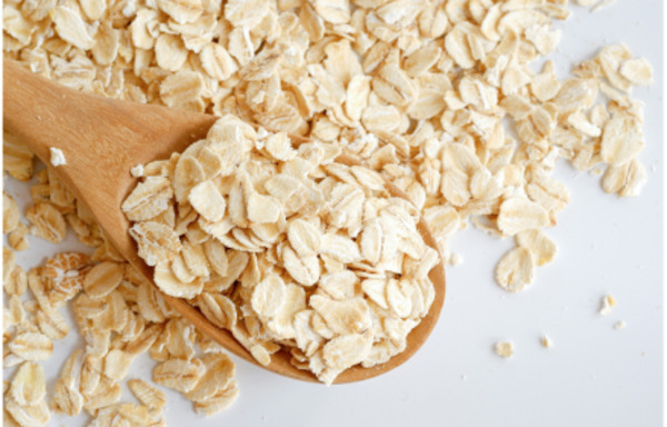 Old fashioned oats on a wooden spoon